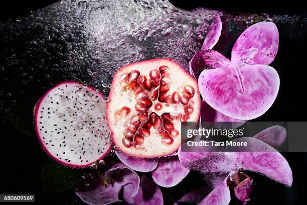 pomegranate and dragon fruit with water - dragon fruit fotografías e imágenes de stock