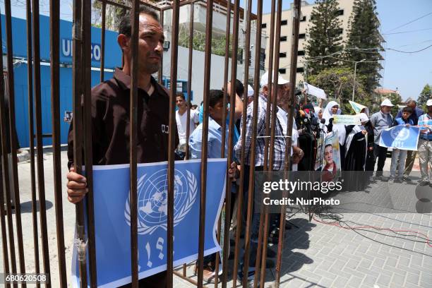 Palestinians hold up cooking pots during a sit-in held to show solidarity with Palestinian prisoners on hunger strike in Israeli Jails,In front of...