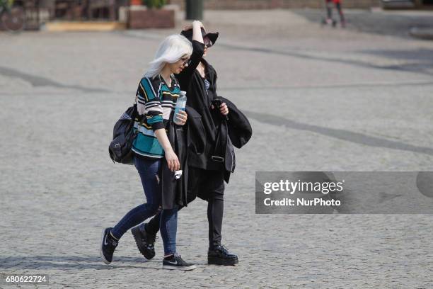 Fashionable young teenagers are seen crossing the Old Market Square in Bydgoszcz, Poland on 6 May, 2017.