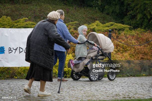 Young child is seen gazing at an elderly woman on the Mill Island in Bydgoszcz, Poland on 6 May, 2017.