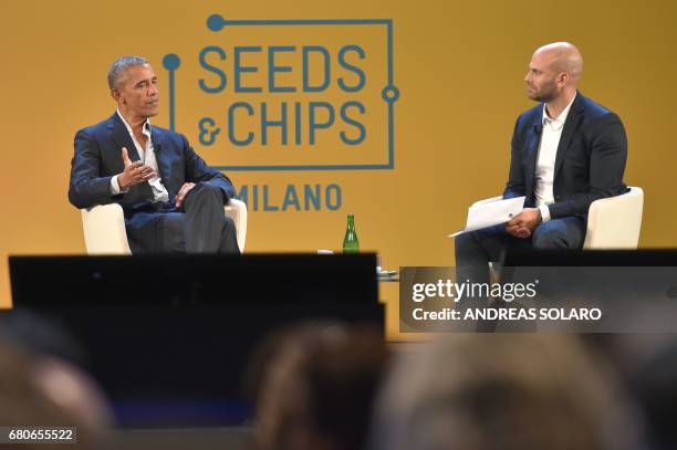 Former President Barack Obama speaks with Sam Kass, food entrepreneur and former White House chef, during the third edition of "Seed & Chips: The...