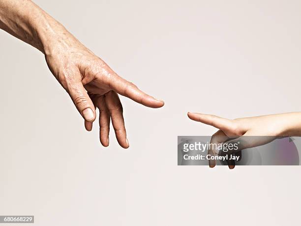 young and old hands point together - touching stock pictures, royalty-free photos & images