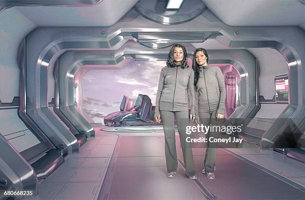 two women in futuristic apartment - jay space stock pictures, royalty-free photos & images