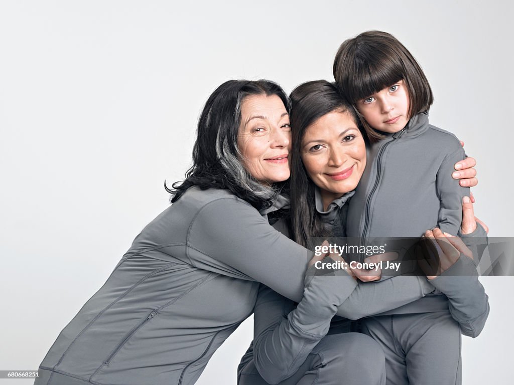 Three generations of women hugging.