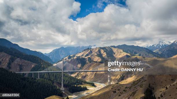 the fruit valley bridge connect mountains in west china - silk road stock pictures, royalty-free photos & images