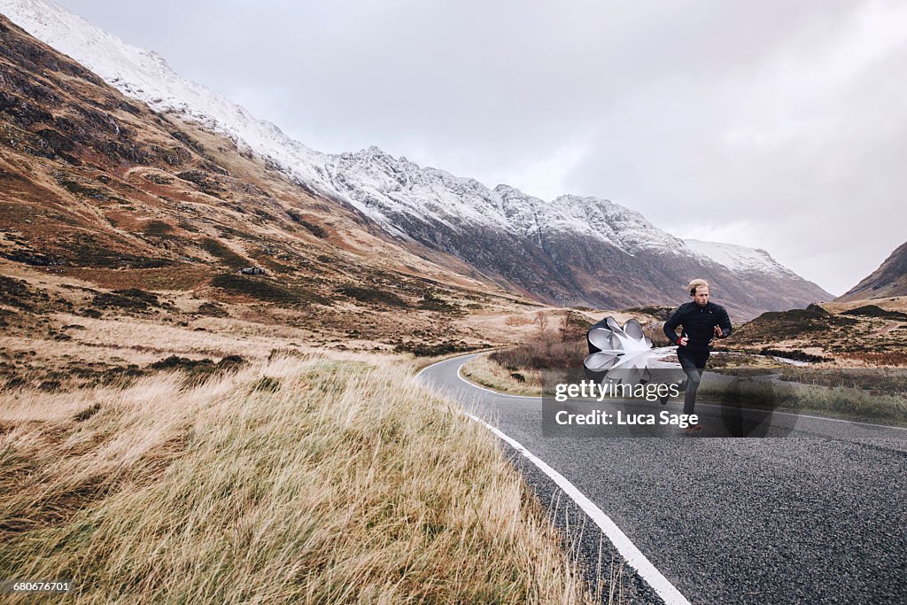 Man sprint training on a Scottish mountain road