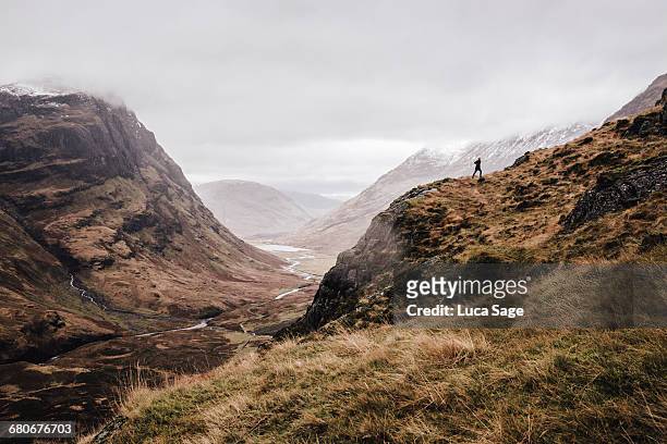 a free runner along a mountain landscape - scotland mountains stock pictures, royalty-free photos & images