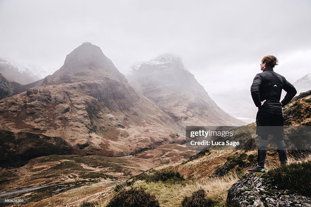 A runner stops to enjoy the view on a mountain run