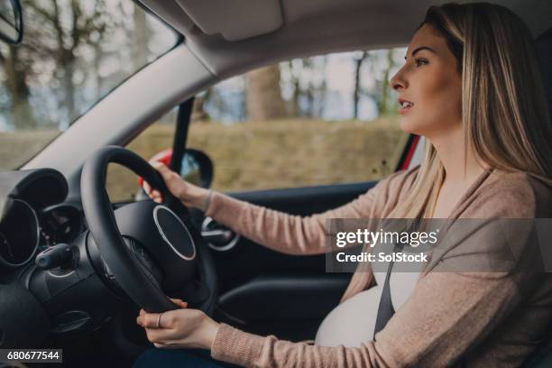 pregnant woman driving - pregnant woman car stock pictures, royalty-free photos & images