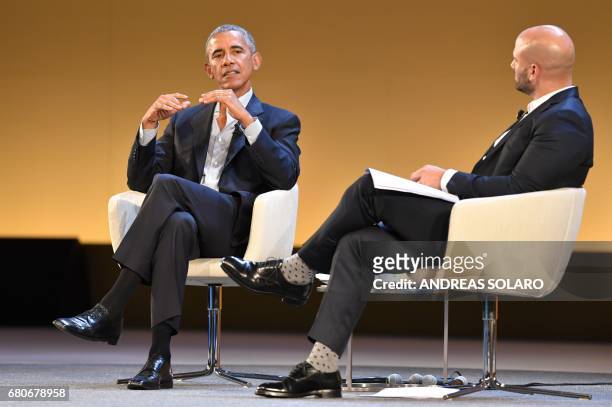 Former President Barack Obama speaks with Sam Kass, food entrepreneur and former White House chef, during the third edition of "Seed & Chips: The...