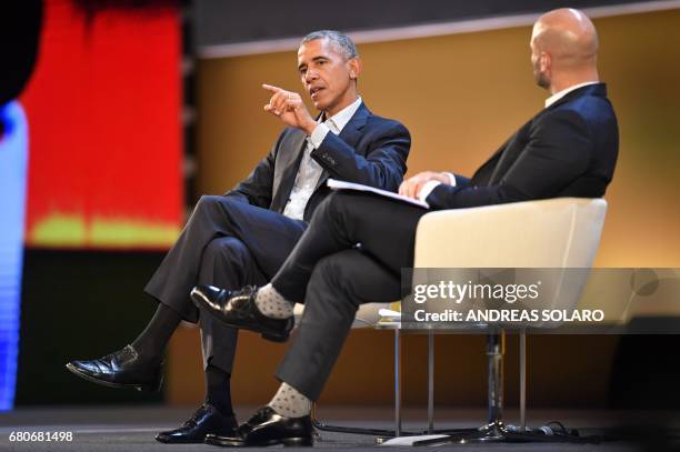 Former President Barack Obama speaks with Sam Kass, food entrepreneur and former White House chef, during the third edition of "Seed & Chips: The...