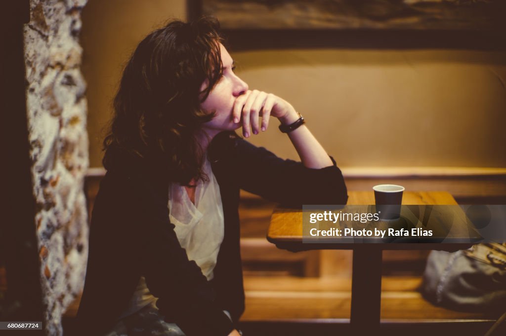 Woman deep in thought at the bar