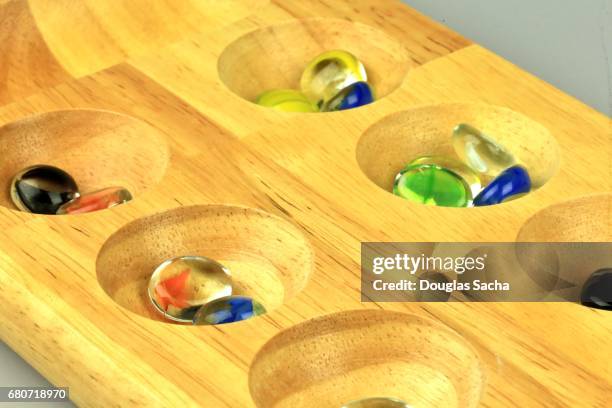 standard mancala game board and marbles - wari imagens e fotografias de stock