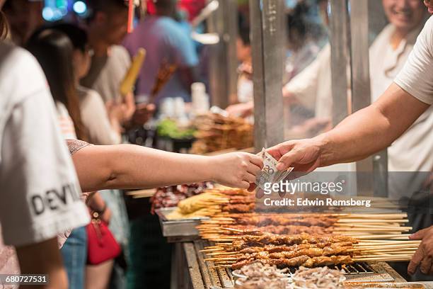 customer buying food at donghuamen snack market - cash in transit stock pictures, royalty-free photos & images