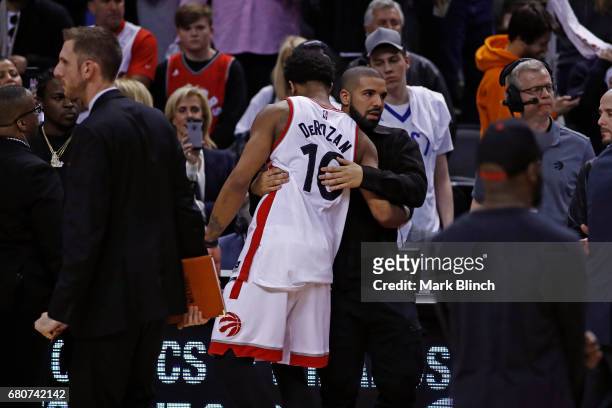 Rapper, Drake greets DeMar DeRozan of the Toronto Raptors after Game Four of the Eastern Conference Semifinals against the Cleveland Cavaliers during...