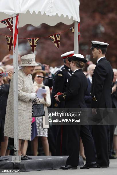 Britain's Queen Elizabeth II presents the Queen's gold medals to outstanding students and Chief Cadet Captains, Ellen White and Fred Taucher during...