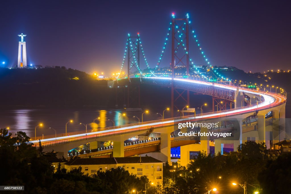 Lisbon 25 de Abril Bridge landmarks illuminated at dusk Portugal