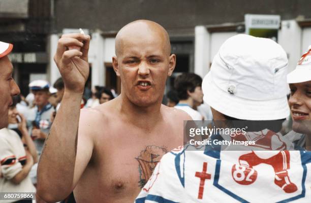 An skinhead England fan reacts whilst holding a cigarette at the 1982 World Cup in Spain.