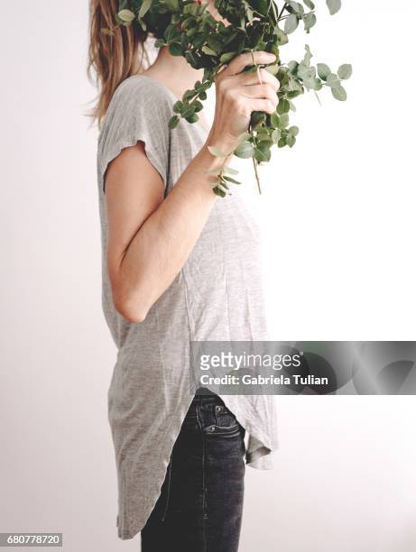 woman hiding her face with a plant bouquet - planta stock pictures, royalty-free photos & images