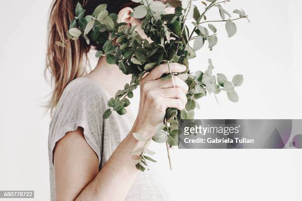 woman hiding her face with a plant bouquet - planta stock pictures, royalty-free photos & images