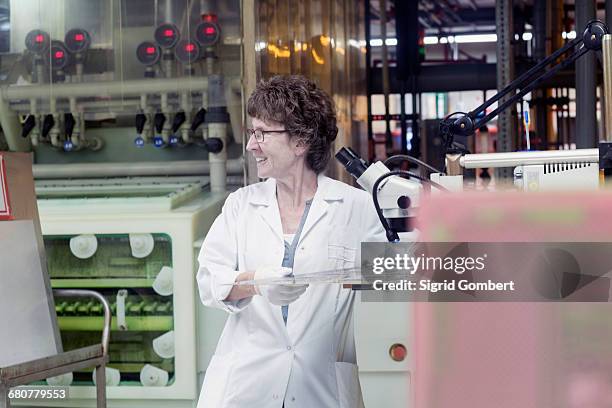 female engineer examining circuit board in industry, hanover, lower saxony, germany - newtechnology stock pictures, royalty-free photos & images