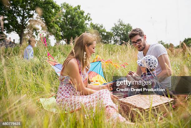 family enjoying picnic in the countryside, bavaria, germany - picknick stock-fotos und bilder