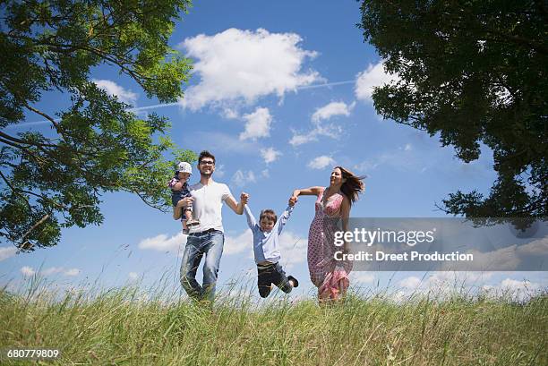 happy family enjoying on meadow in the countryside, bavaria, germany - baby lachen natur stock-fotos und bilder