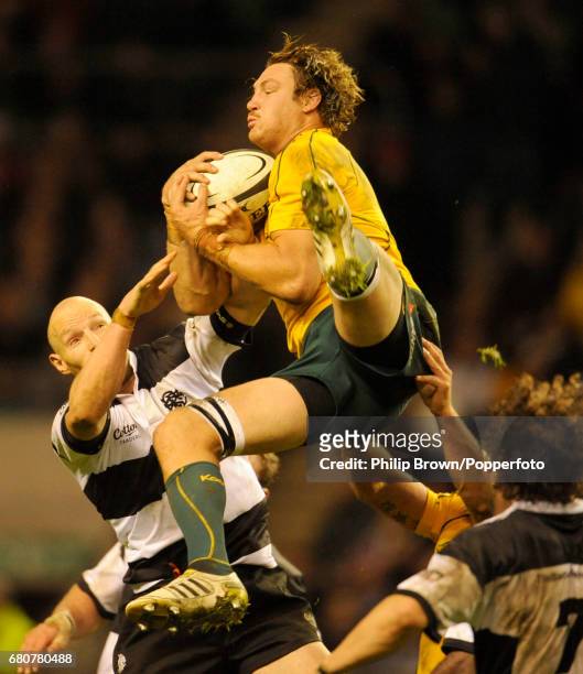 Scott Higginbotham of Australia grabs the ball despite the attentions of Stirling Mortlock of The Barbarians during the Killik Cup match between The...