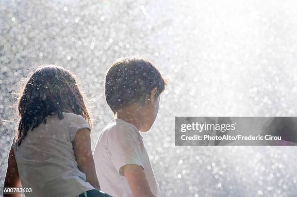 children surrounded by spray from waterfall - cascade france stock pictures, royalty-free photos & images