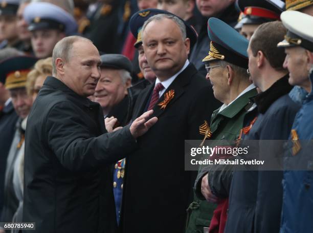 Russian President Vladimir Putin and Moldovan President Igor Dodon attend the Victory Day military parade to celebrate the 72nd anniversary of the...