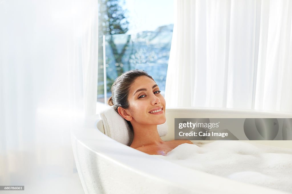 Portrait smiling woman relaxing enjoying bubble bath