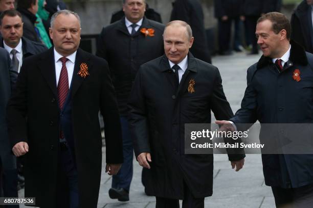 Moldovan President Igor Dodon, Russian President Vladimir Putin and Russian Prime Minister Dmitry Medvedev attend the Victory Day military parade to...