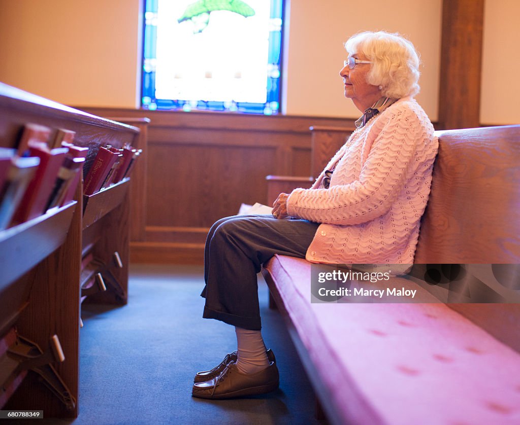 Senior woman sitting in chapel