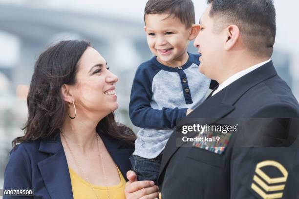 hispanic military man with little boy and wife - military family stock pictures, royalty-free photos & images