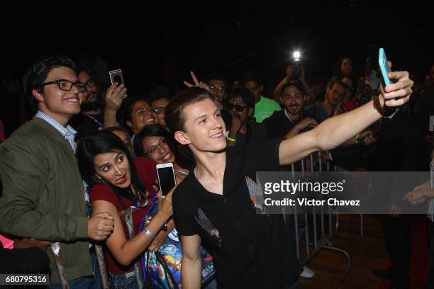 Actor Tom Holland takes selfies with fans during CONQUE to promote the new film "Spider-Man: Homecoming" at Centro De Congresos De Queretaro on May...