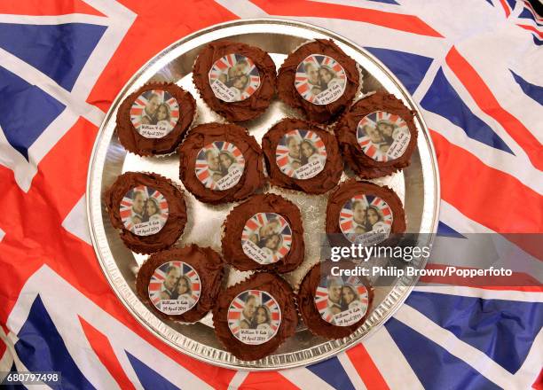 Plate of small cakes decorated with photographs of the newlyweds on display at a gathering in Bucklebury near Reading on the day that Kate Middleton...