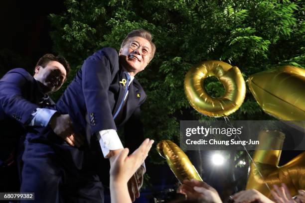 South Korean President-elect Moon Jae-in, of the Democratic Party of Korea, celebrates with supporters at Gwanghwamun Square on May 9, 2017 in Seoul,...