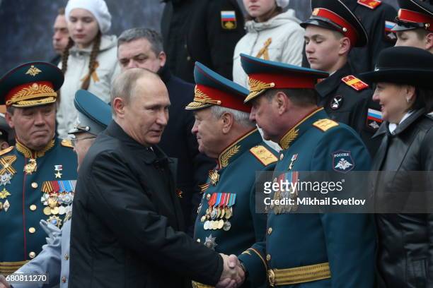 Russian President Vladimir Putin greets Deputy Defence Minister Yuri Borisov during the Victory Day military parade to celebrate the 72nd anniversary...