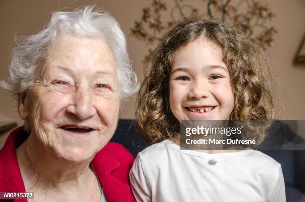 grandmother and granddaughter both showing lack of teeth by smiling - lost generation stock pictures, royalty-free photos & images