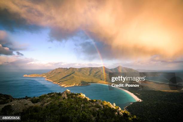 storm cloud passing by mt amos. view towards wineglass bay. freycinet peninsula, tasmania - wineglass bay stock pictures, royalty-free photos & images