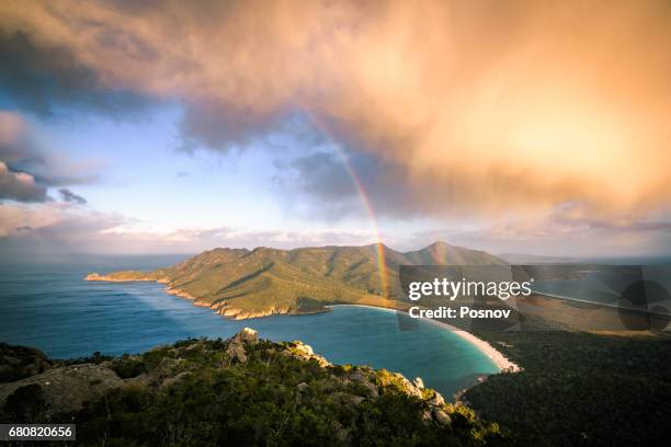 storm cloud passing by mt amos. view towards wineglass bay. freycinet peninsula, tasmania - wine glass bay tasmania stock pictures, royalty-free photos & images