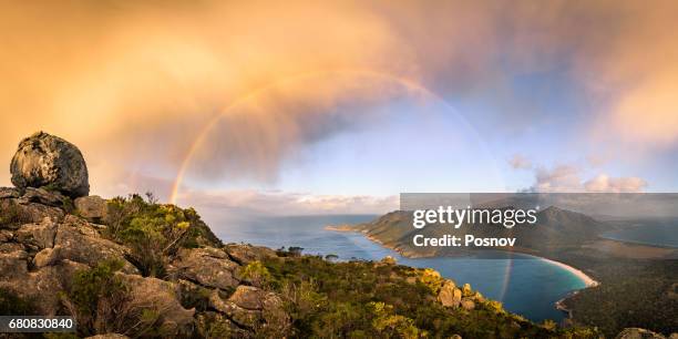 storm cloud passing by mt amos. view towards wineglass bay. freycinet peninsula, tasmania - wineglass bay stock pictures, royalty-free photos & images