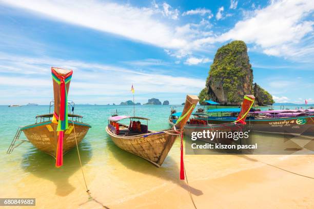 typical long tail boat in island of thailand - krabi provincie stockfoto's en -beelden