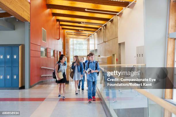 students walking in corridor - inside locker stock pictures, royalty-free photos & images