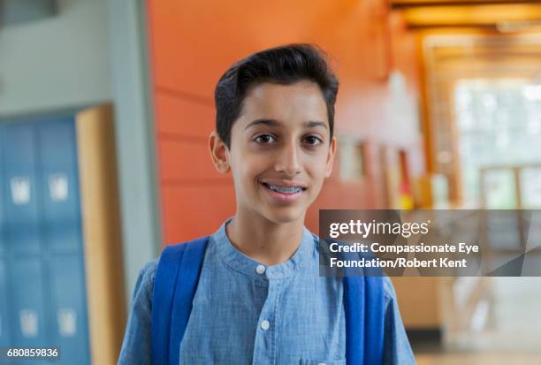 portrait of smiling student in corridor - 12 13 anos - fotografias e filmes do acervo