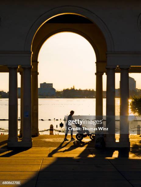 woman with stroller at the lake - alameda county stock pictures, royalty-free photos & images