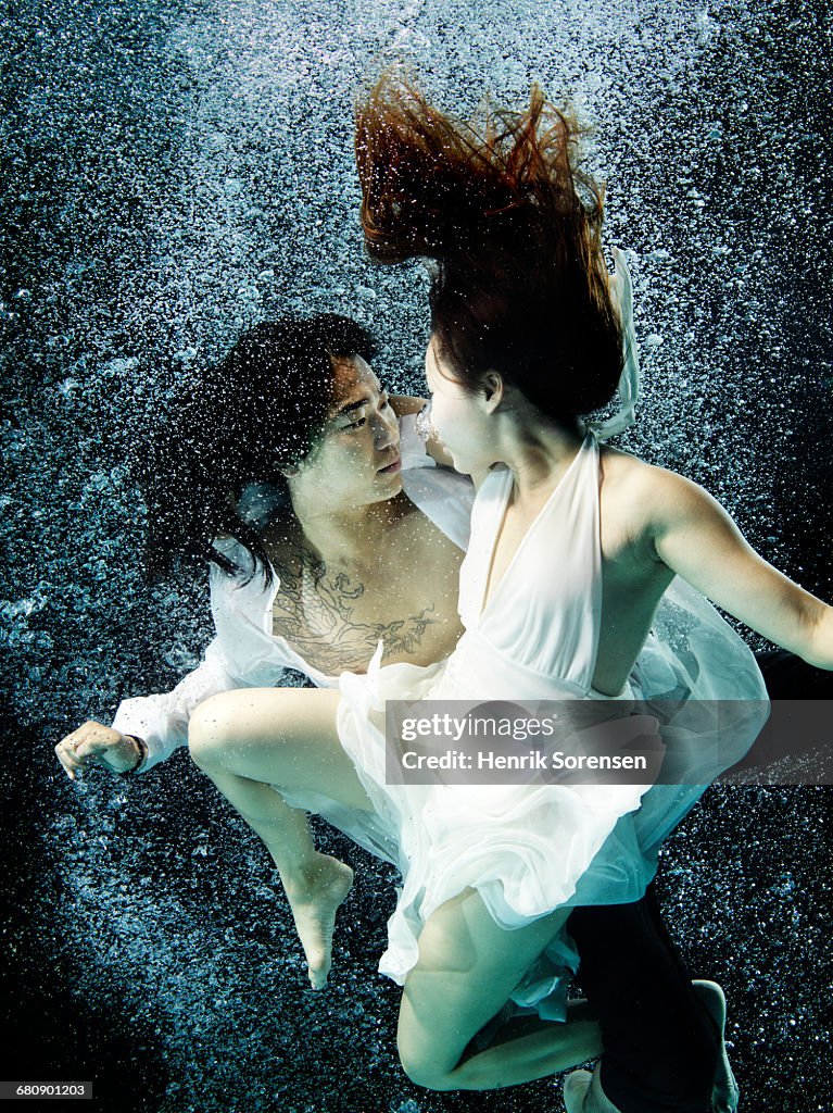 Asian couple under water