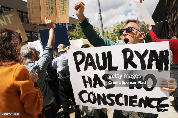 Dozens of health care activists protest in front of a Harlem charter school before the expected visit of House Speaker Paul Ryan on May 9, 2017 in...