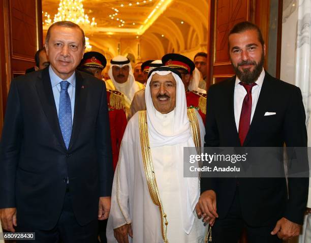 Turkish President Recep Tayyip Erdogan is bidden farewell by Kuwaiti Emir Sheikh Jaber al-Ahmad al-Sabah and Turkish actor Engin Altan Duzyatan at...