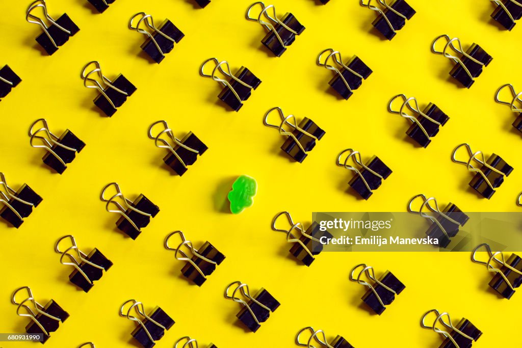Singled Out. Binder clips and green jelly bean frog